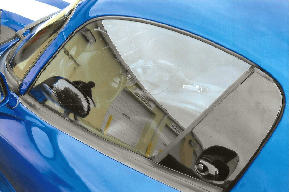 Reflection in a blue sports car window