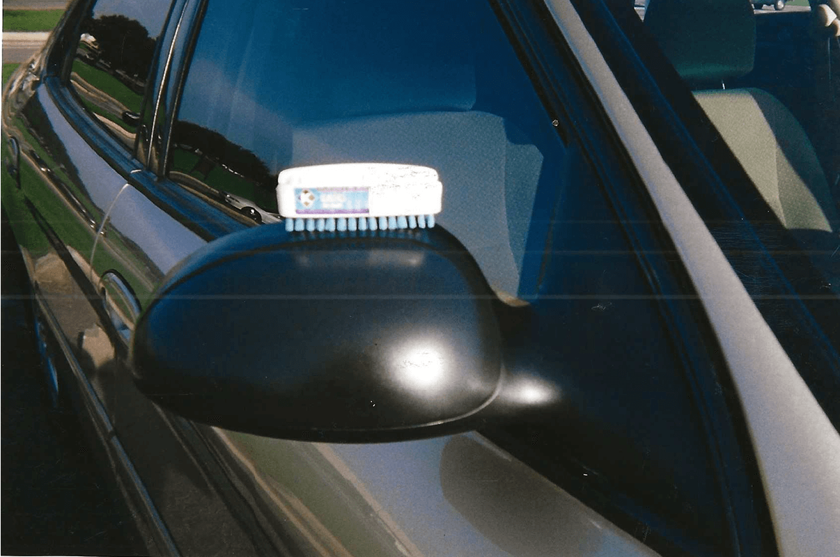 Car side mirror with a brush