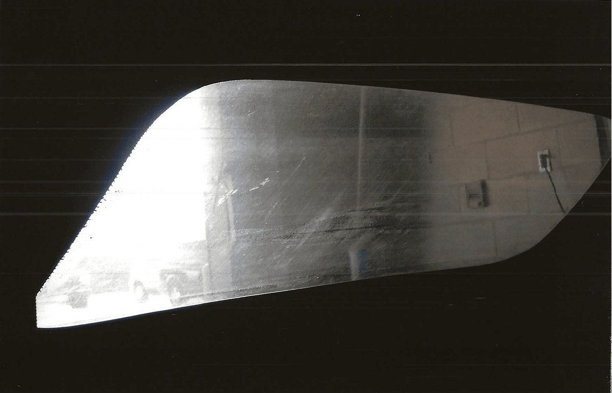 Car window fogged up, being wiped clean by a hand.