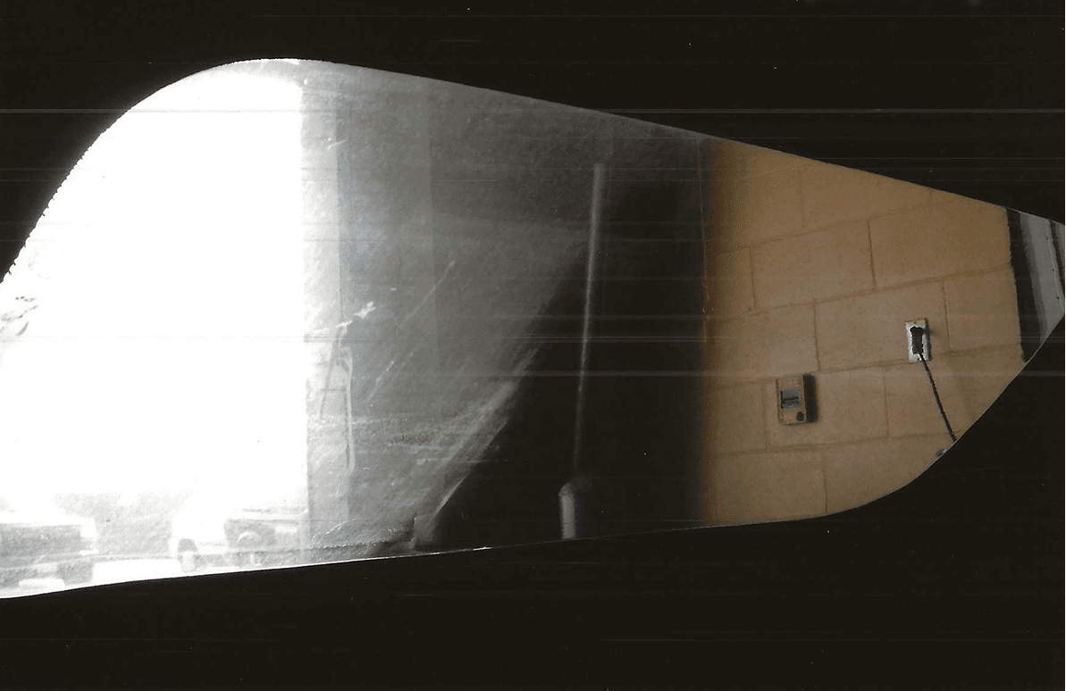 Dimly lit hallway with light casting shadows on the floor.