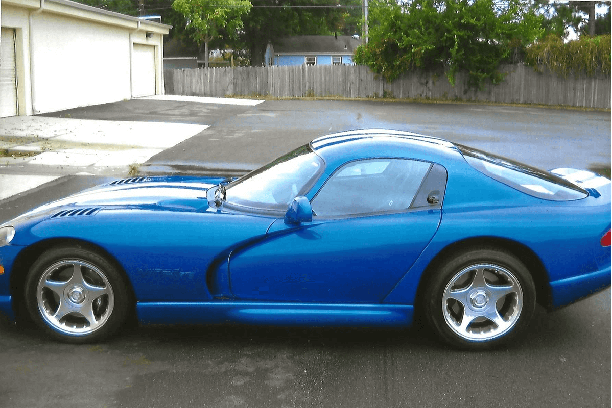 Blue sports car parked in driveway